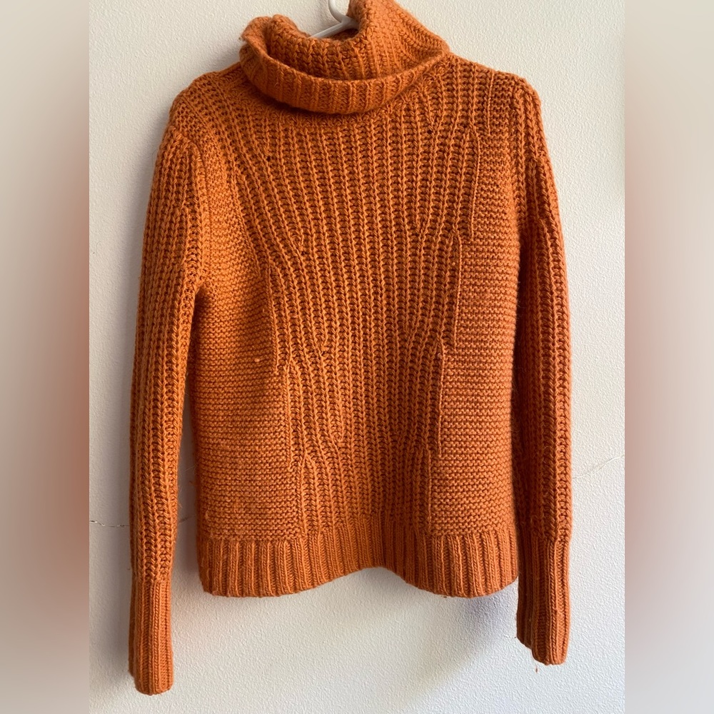 Turtleneck sweater in orange color.